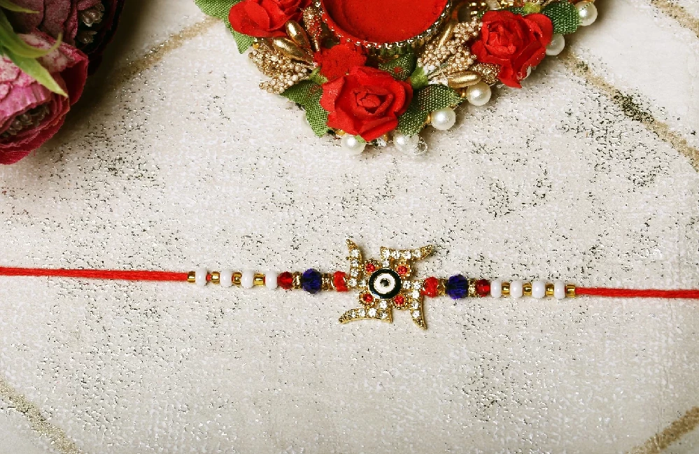 Swastik Rakhi with Evil Eye in Center - Image 1